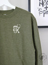 Essentials: Cup + Stethoscope with "EMS" on a Army Green sweatshirt