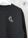 Essentials: Cup + ID Badge with "HCA" on a Black sweatshirt
