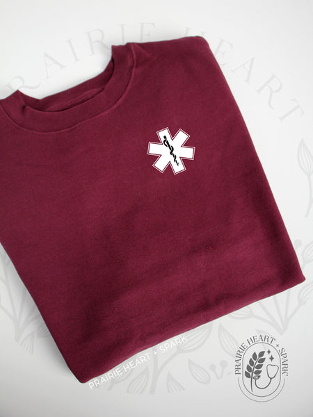 EMS Star: Black colour Rod of Asclepius on a Maroon sweatshirt