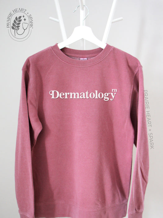 Flock Your Creds: Pink sweatshirt with "Dermatology - RN" 