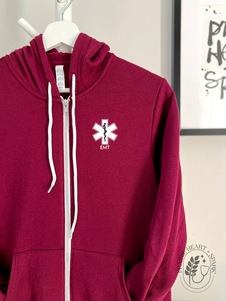 EMS Star: Black colour Rod of Asclepius with EMT on a Maroon zip up hoodie