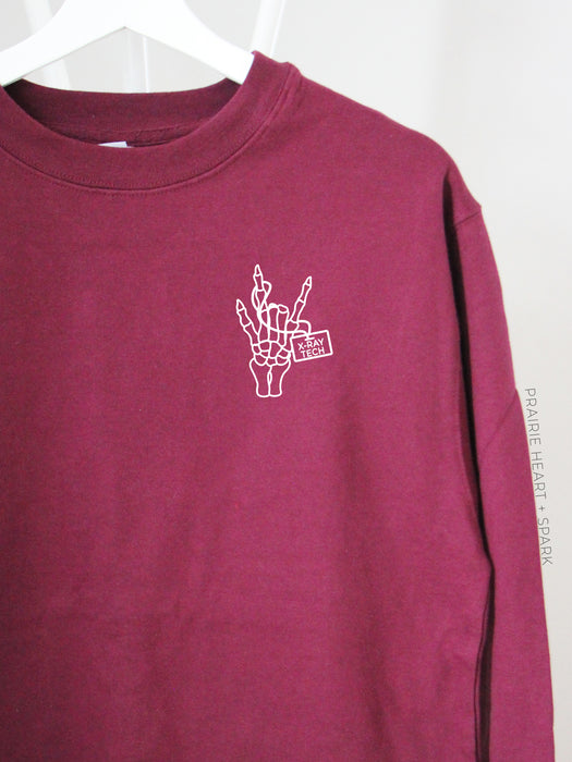 Spooky Rock On with X-Ray Tech on a Maroon sweatshirt