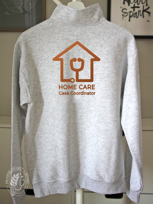 Ash grey quarter-zip sweatshirt with 'Home Care Case Coordinator' logo in copper.