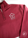 Maroon quarter-zip sweatshirt with 'Home Care Case Coordinator' logo in silver (mock up)