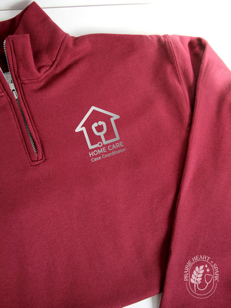 Maroon quarter-zip sweatshirt with 'Home Care Case Coordinator' logo in silver (mock up)