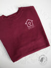 Maroon sweatshirt with a rose gold logo on the front of the shirt (mock up)